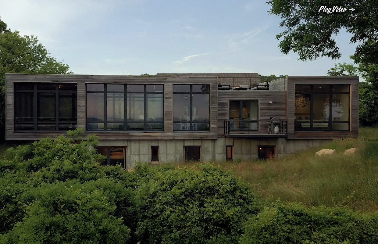 Modern glass-front home by Hutker Architects with wood and concrete exterior on Martha’s Vineyard