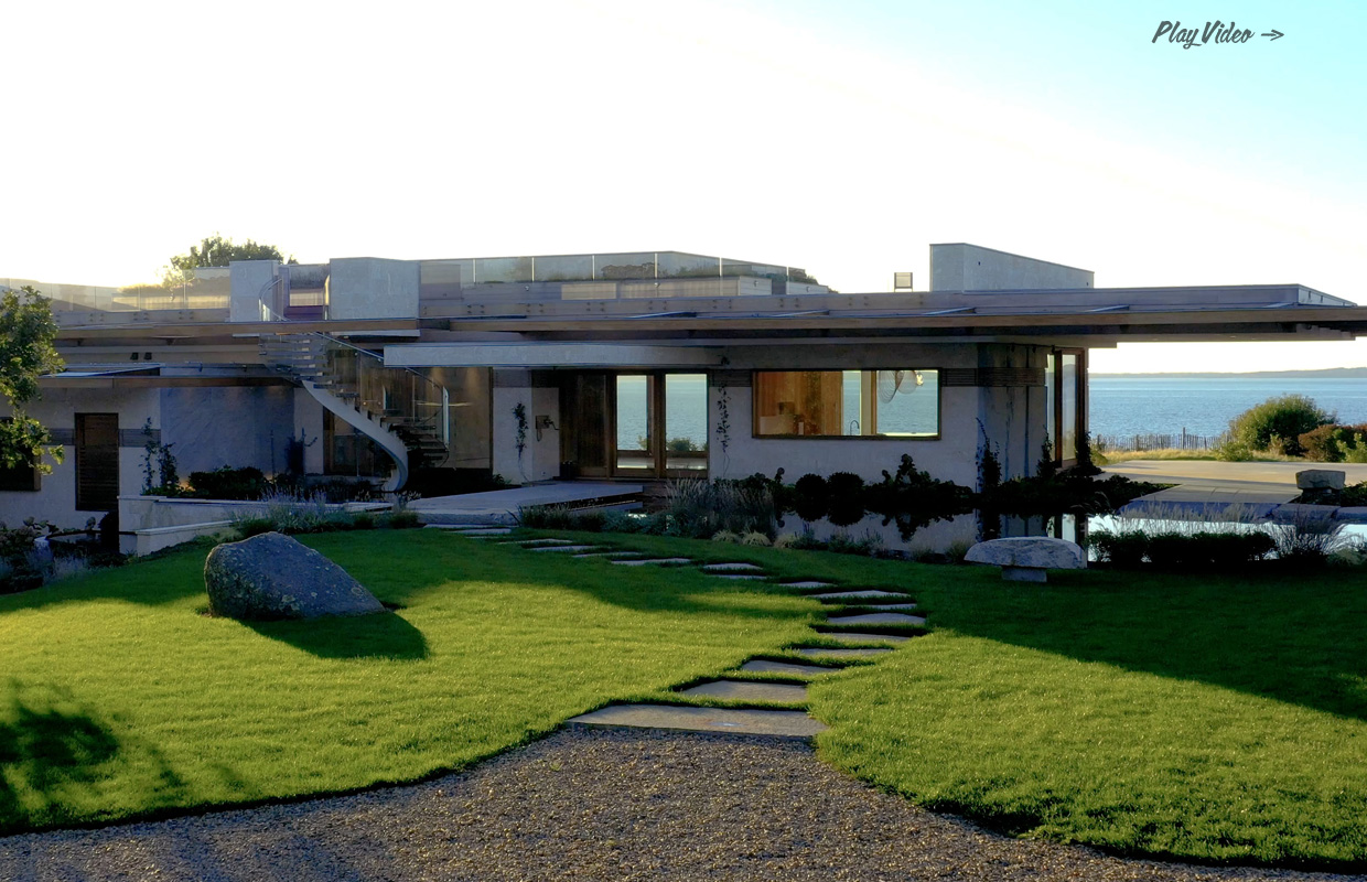 Modern concrete home by Tate Builders with ocean view and spiral glass staircase